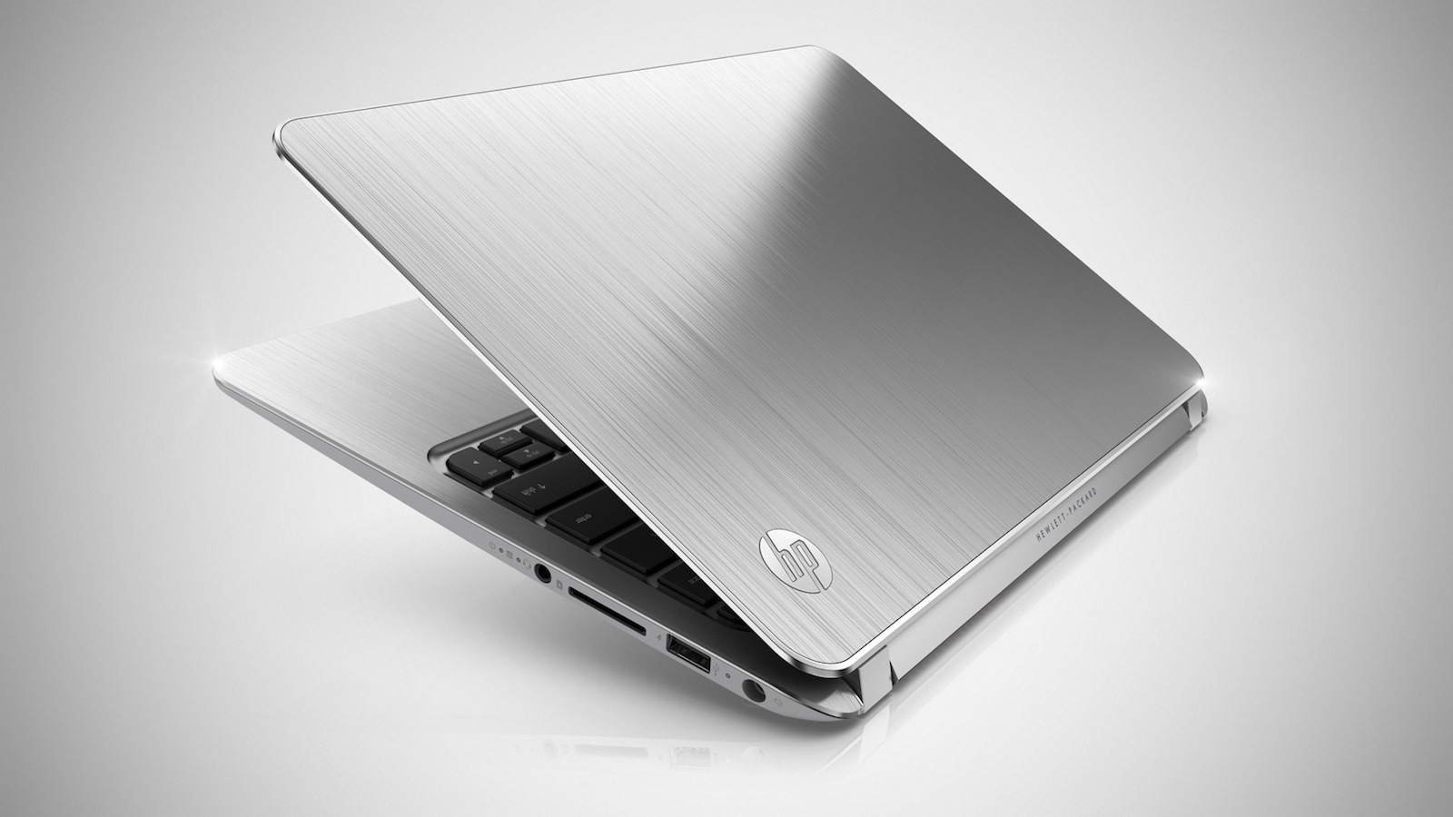 Slim silver HP laptop with brushed metal finish, lid partially open to reveal the keyboard.