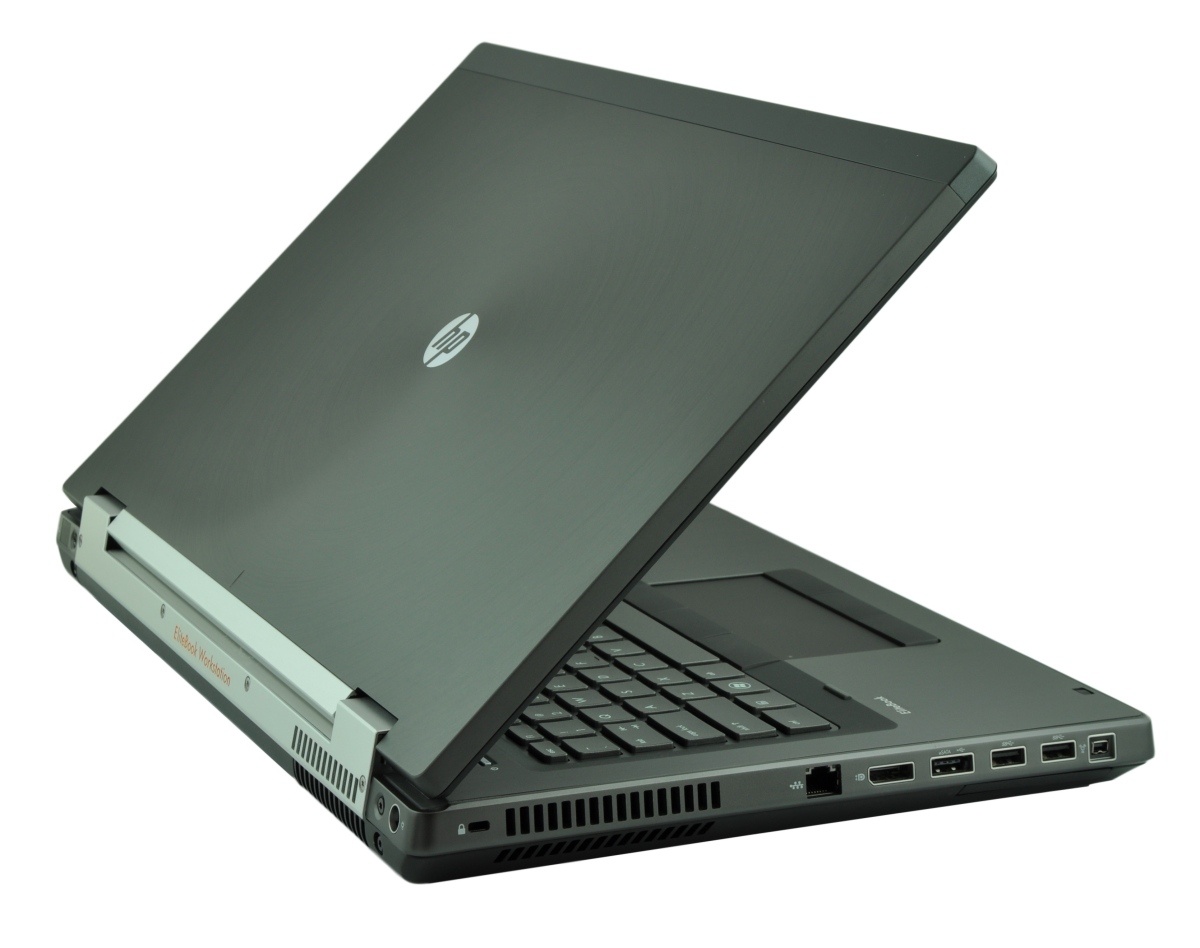 Open HP laptop in a dark gray chassis, angled to show keyboard and rear docking connector at the back.