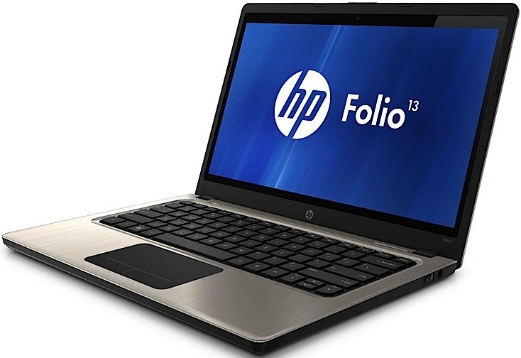 CREATOR gd-jpeg v10 using IJG JPEG v62 quality = 90 - lab-kuzniewski.pl - Testy laptopów, recenzje i porównania Open HP Folio 13 laptop with silver brushed-metal deck and black keyboard, screen shows HP Folio 13 on blue background