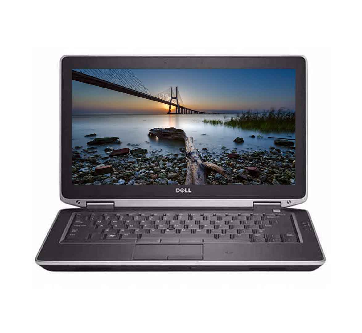 Open Dell laptop showing a sunset landscape on the screen with a bridge over water.