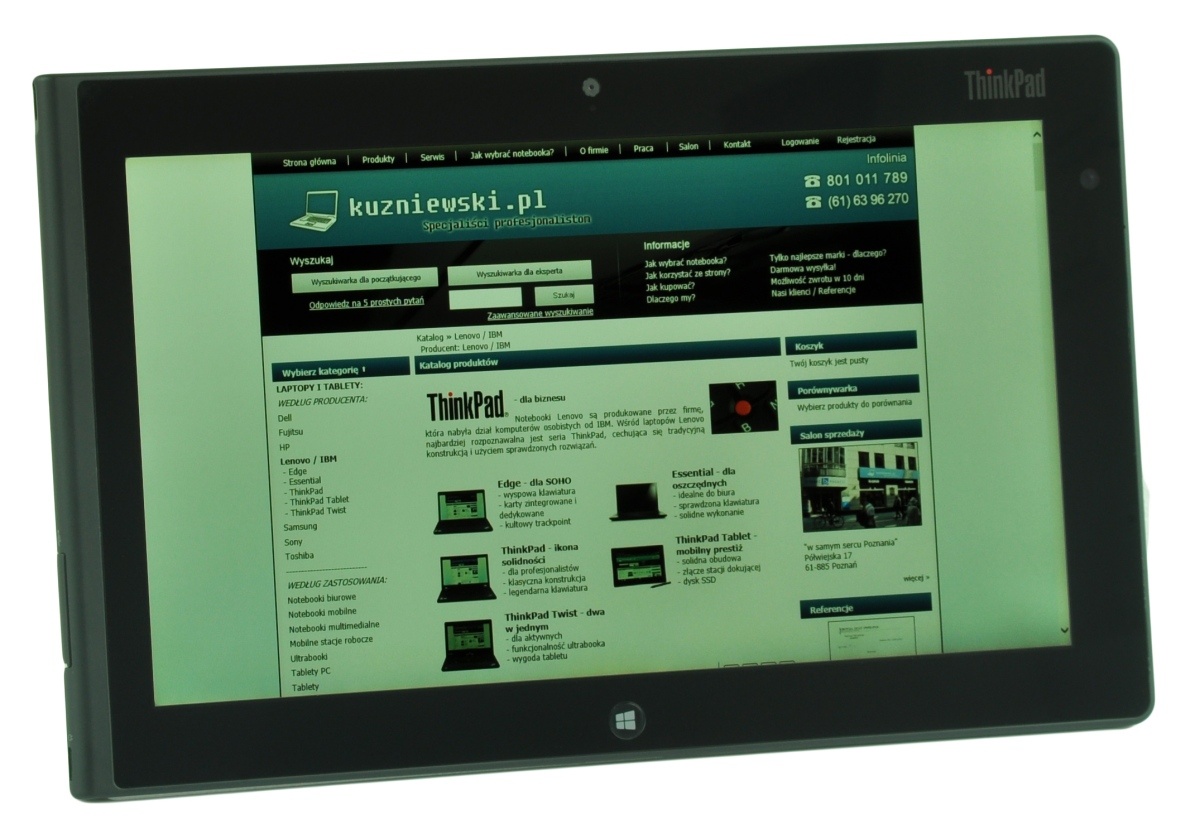 ThinkPad tablet displaying the kuzniewski.pl website on its screen, angled for a photo.
