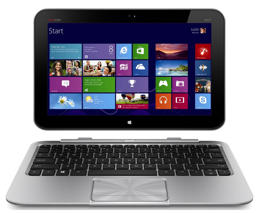 Windows tablet on a detachable keyboard displaying the Start screen with colorful tiles