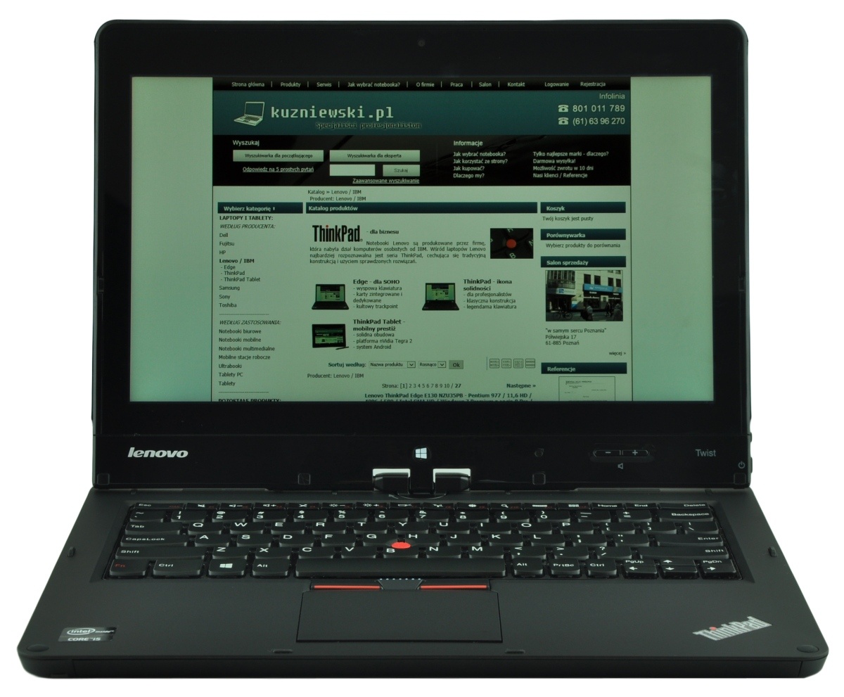 Lenovo ThinkPad laptop open, displaying the kuzniowski.pl homepage on its screen.