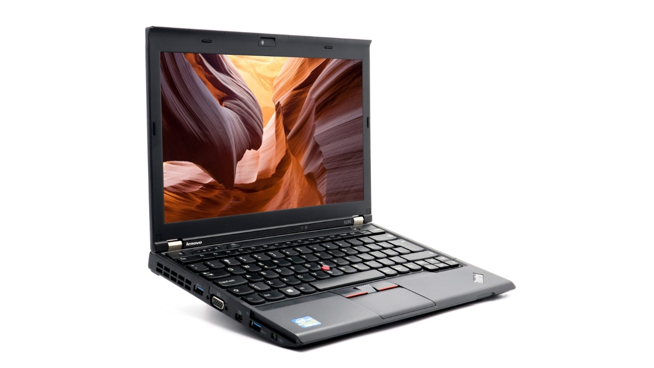 Lenovo ThinkPad X230i_0906_02 - lab-kuzniewski.pl - Testy laptopów, recenzje i porównania Open Lenovo ThinkPad laptop on white background, screen showing a canyon wallpaper.