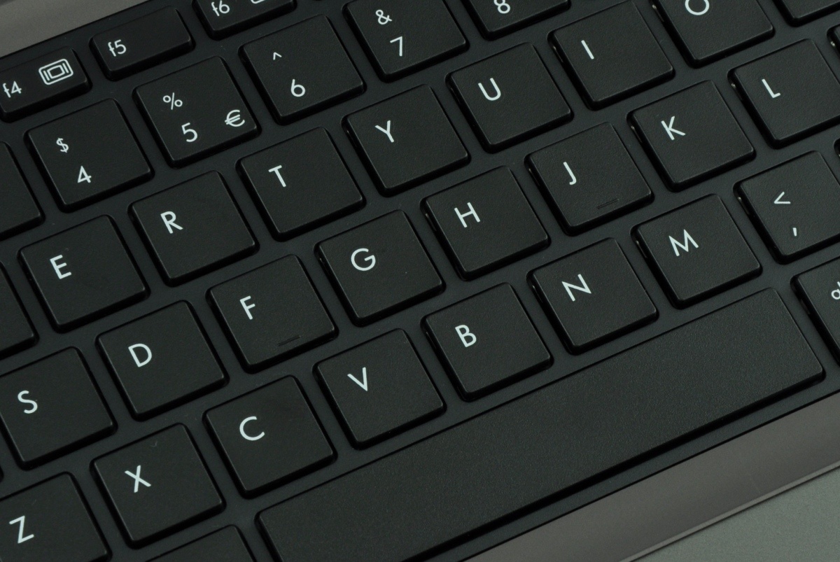 Close-up of a black laptop keyboard with white-letter keys.