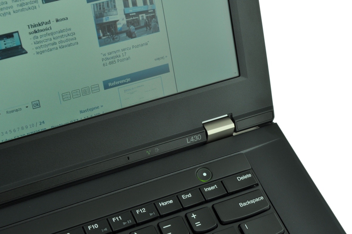 Open ThinkPad laptop displaying a webpage on the screen; keyboard in the foreground.