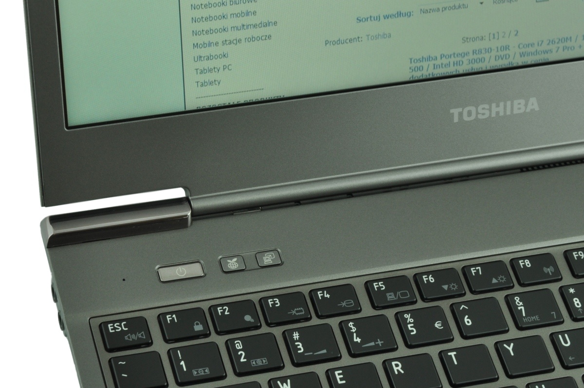 Close-up of a Toshiba laptop keyboard and hinge with the Toshiba logo on the palmrest area