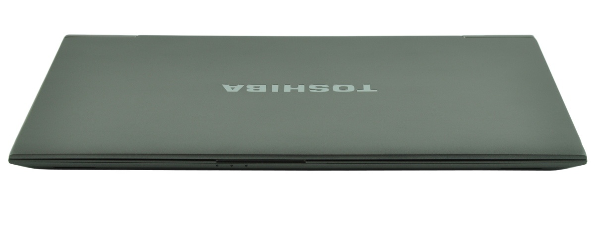 Closed Toshiba laptop seen from above, gray lid with brand logo visible in the center