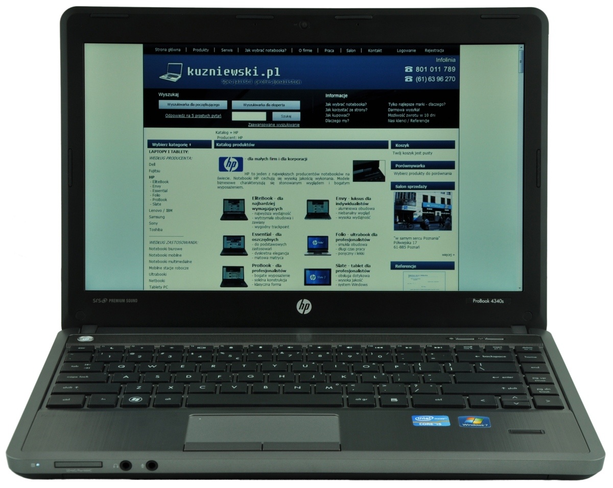 Open HP laptop displaying kuzniewski.pl with a blue header and product catalog on the screen, showing navigation and thumbnails.