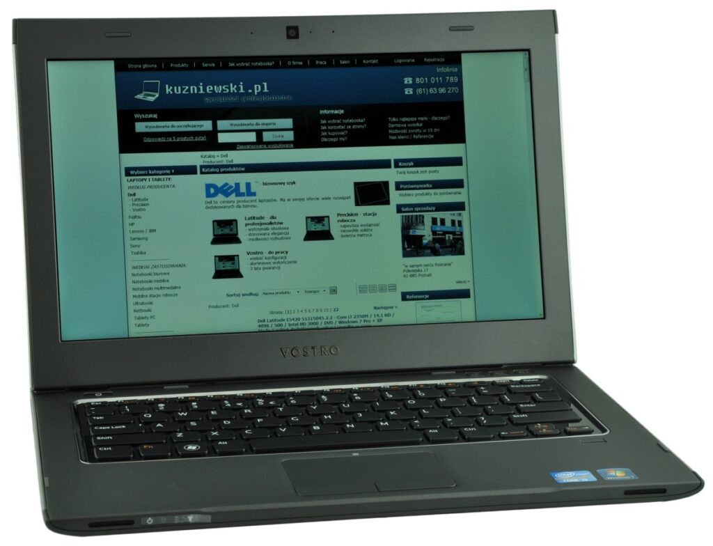 Laptop computer opened at slight angle showing a Dell-style webpage on screen; blue-dominated site content visible on display.
