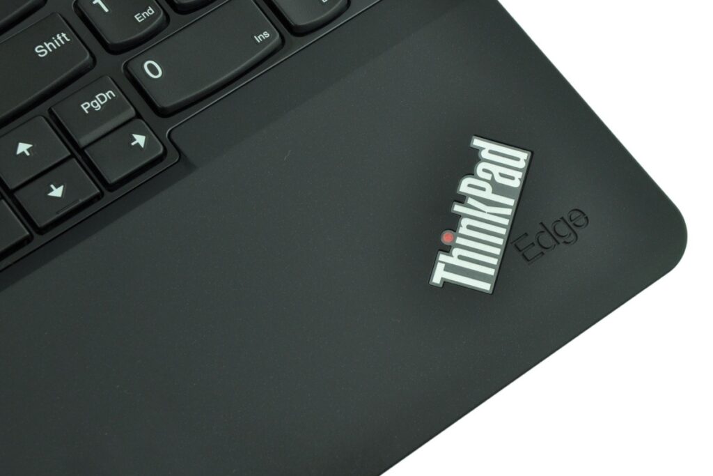 Close-up of a black ThinkPad Edge laptop lid with the ThinkPad logo visible near the keyboard.