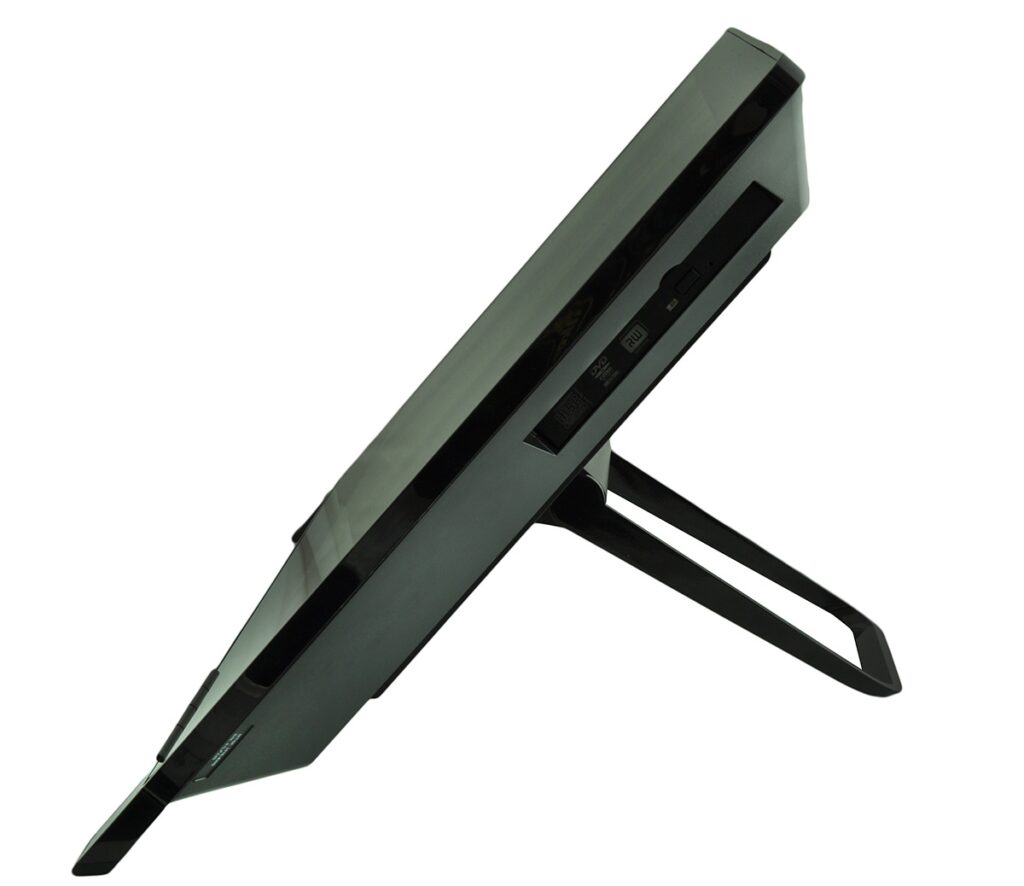 Slim black gaming console mounted on a stand, photographed from the side to show its profile and angled orientation