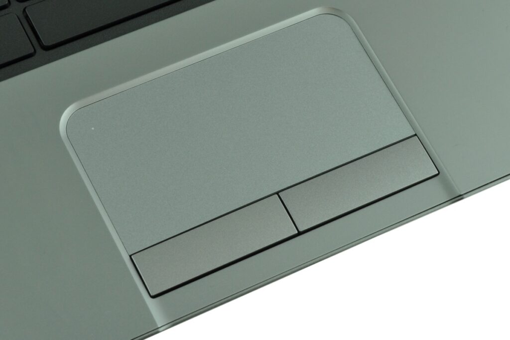 Gray laptop palm rest featuring a large rectangular touchpad with two separate buttons below it.