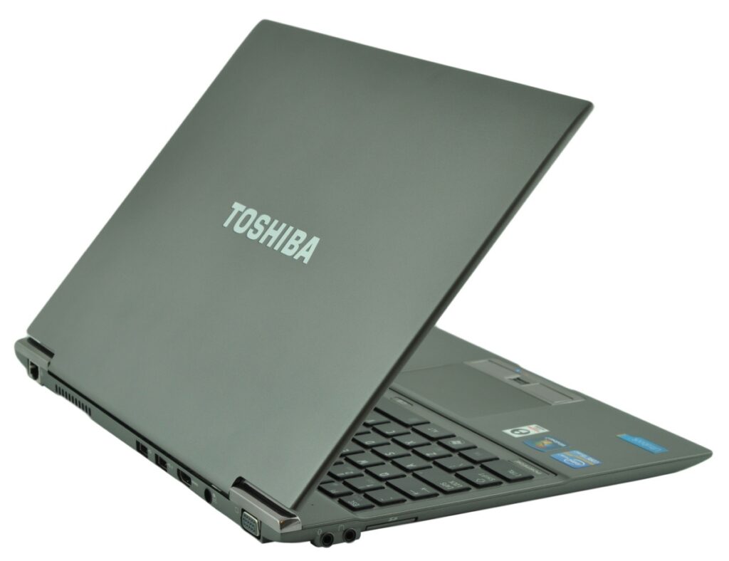 Toshiba laptop partially open, showing the logo on the lid and side ports visible