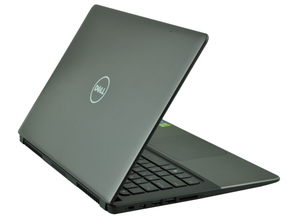 Open Dell laptop in a gray chassis, angled to the right, showing keyboard and side ports on a white background.