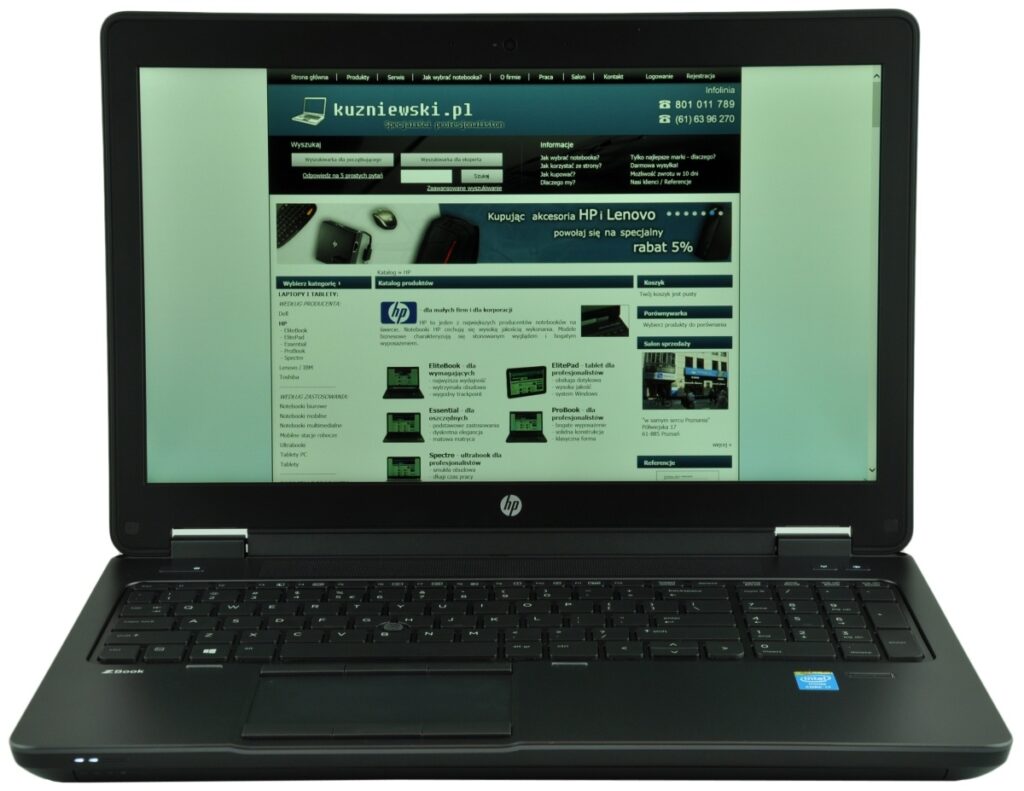Open HP laptop showing a website homepage on the screen, with a teal header and product images in a grid layout.