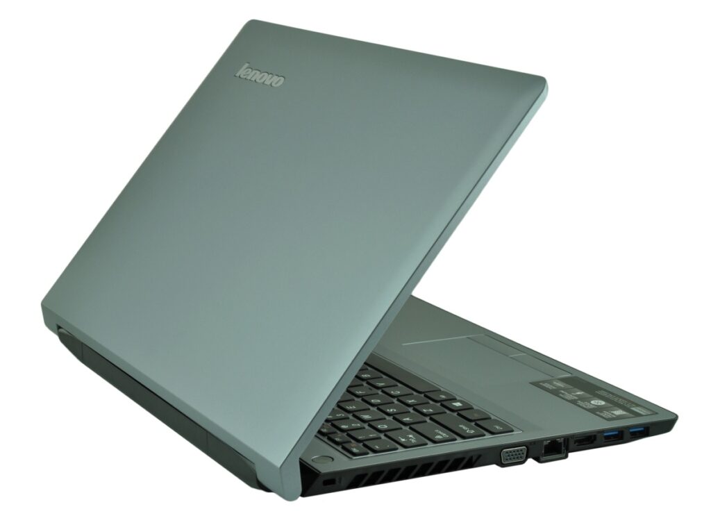 Open Lenovo laptop photographed from an angled side view, showing keyboard and wired ports on the right edge against a white background.