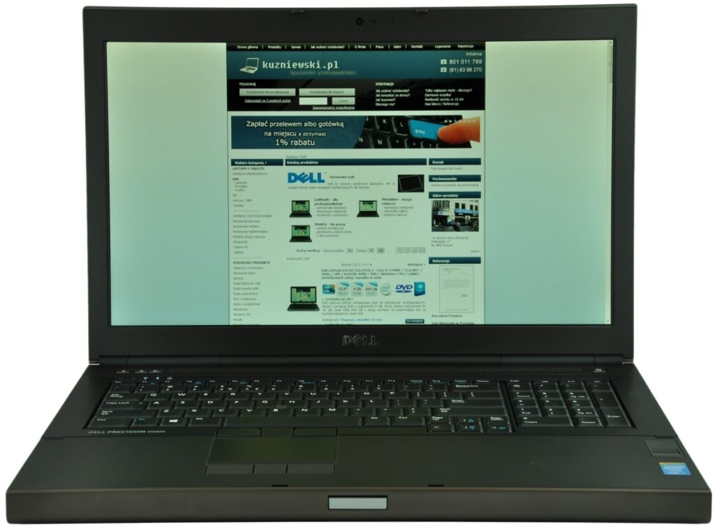 dell-precision-m6800-516_125146 - lab-kuzniewski.pl - Testy laptopów, recenzje i porównania Black Dell laptop displaying a Polish tech website (kuzniewski.pl) on its screen, keyboard open and angled slightly.