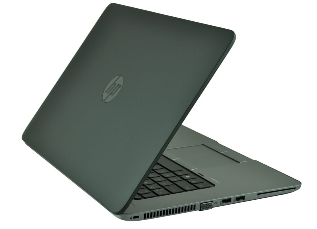 Dark gray HP laptop slightly open, showing keyboard, touchpad, and side ports on the right edge