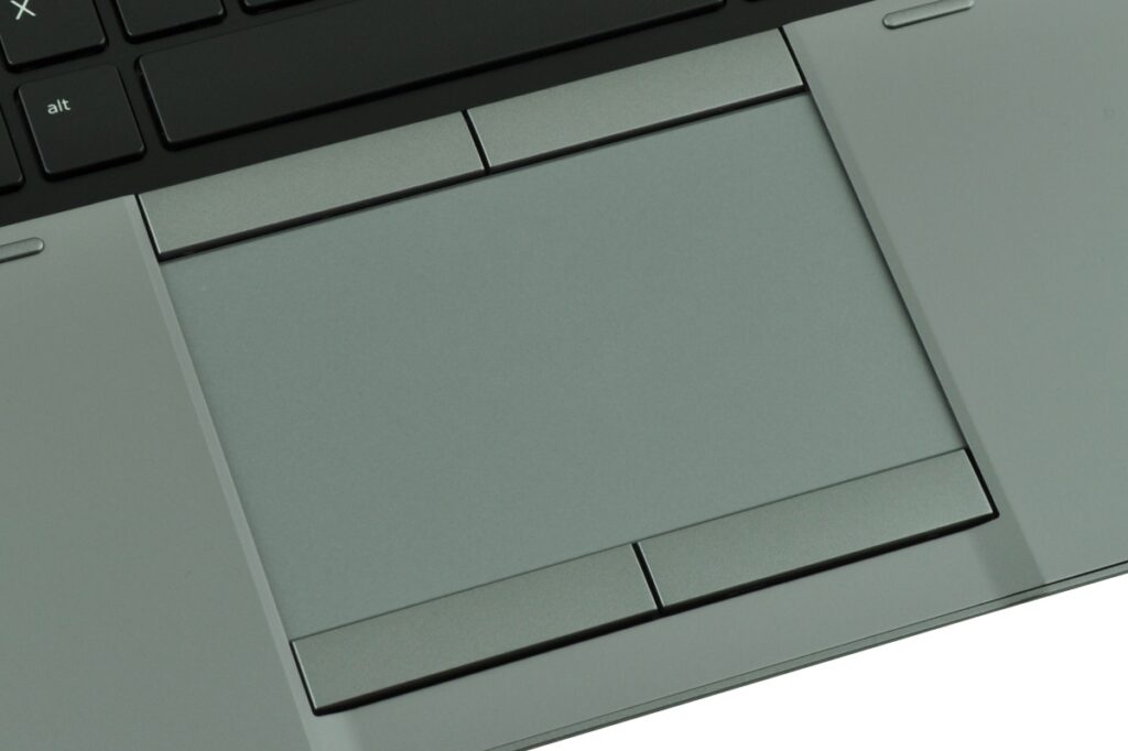 Close-up view of a laptop trackpad and surrounding palm rest.