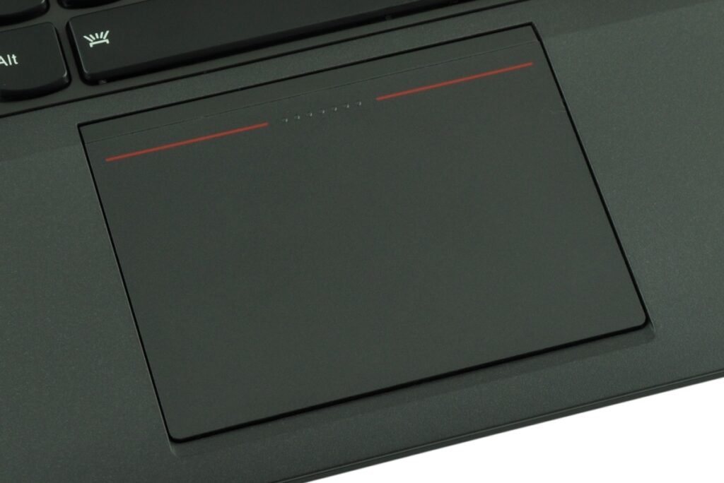 Close-up of a black laptop touchpad with two thin red lines near the top edge.