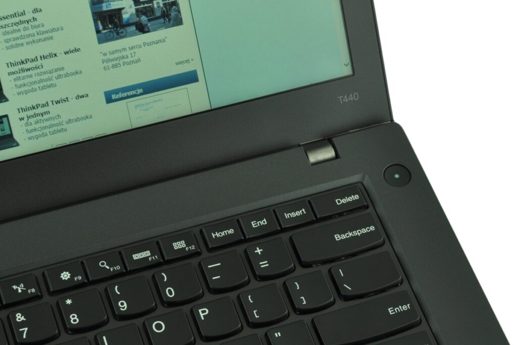 Lenovo ThinkPad T440 laptop with keyboard visible and a webpage on the screen.