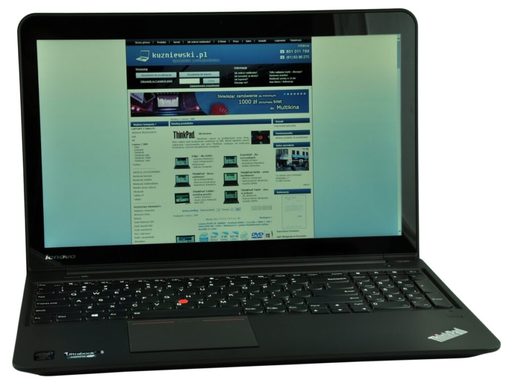 Black Lenovo ThinkPad laptop open with a blue-toned website displayed on the screen.
