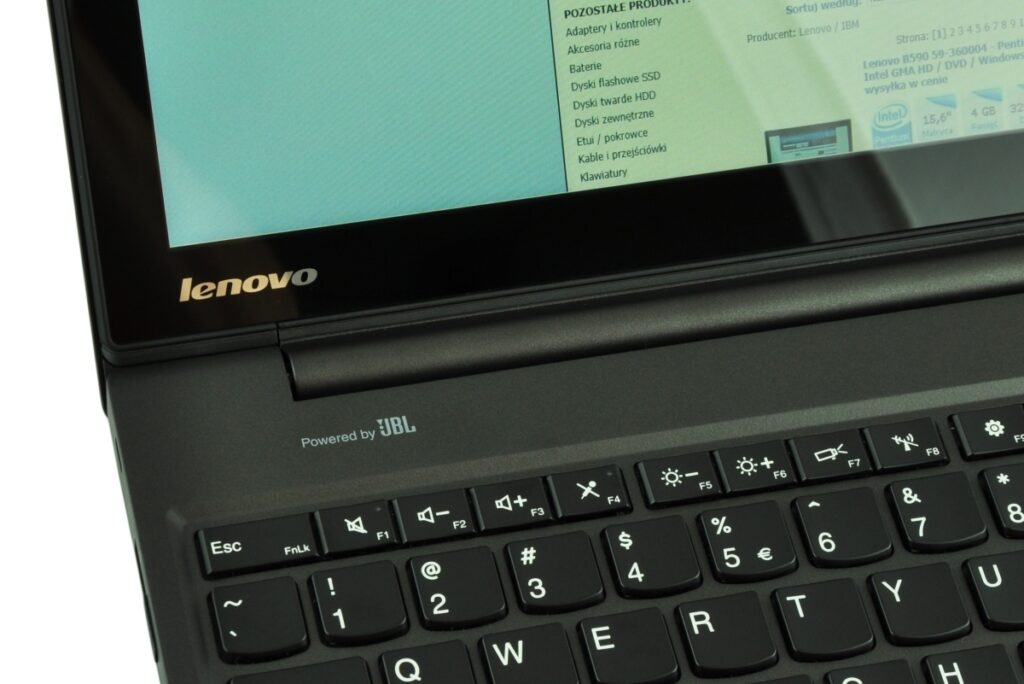 Close-up of a Lenovo laptop keyboard area with 'Powered by JBL' branding on the palmrest.