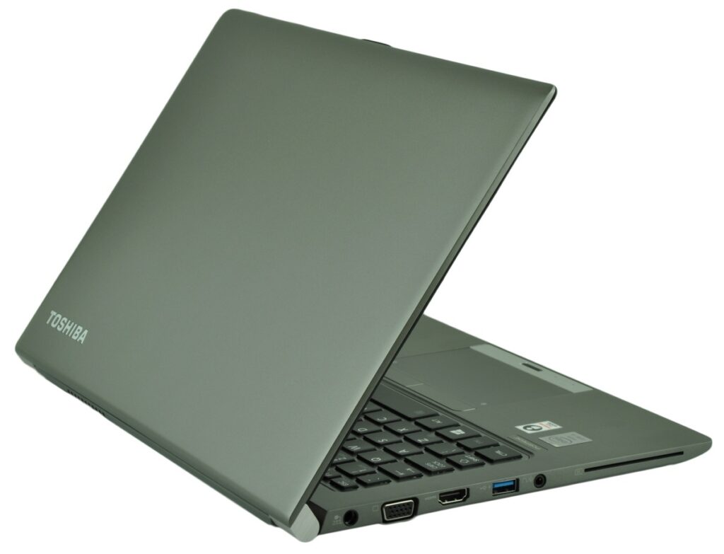 Toshiba laptop shown partially open, angled to reveal left-side ports (HDMI, VGA, USB) on a gray chassis