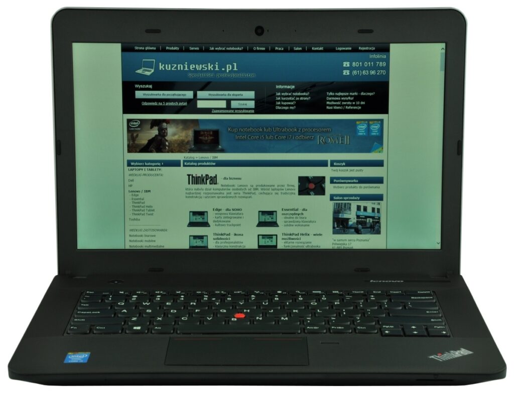Black Lenovo ThinkPad laptop open, screen showing a blue-toned website.