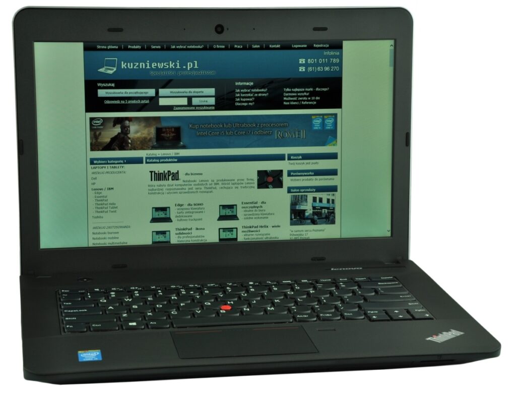 Lenovo ThinkPad laptop open to a Polish tech site kuzniewski.pl loaded in the browser, keyboard visible