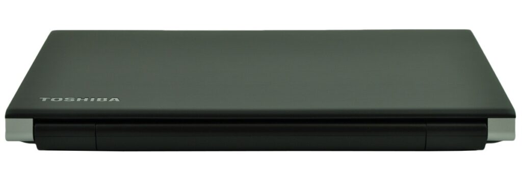 Closed Toshiba laptop on a white background with a matte black lid and silver hinge accents.