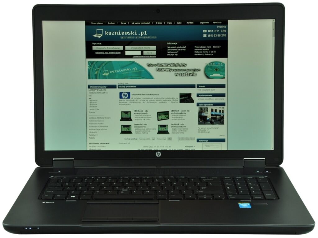 hp-zbook-17-g1-f0v51ea-c_126979 - lab-kuzniewski.pl - Testy laptopów, recenzje i porównania Laptop open to display a Polish website on its screen, with a dark blue header and multiple content blocks on a light background.