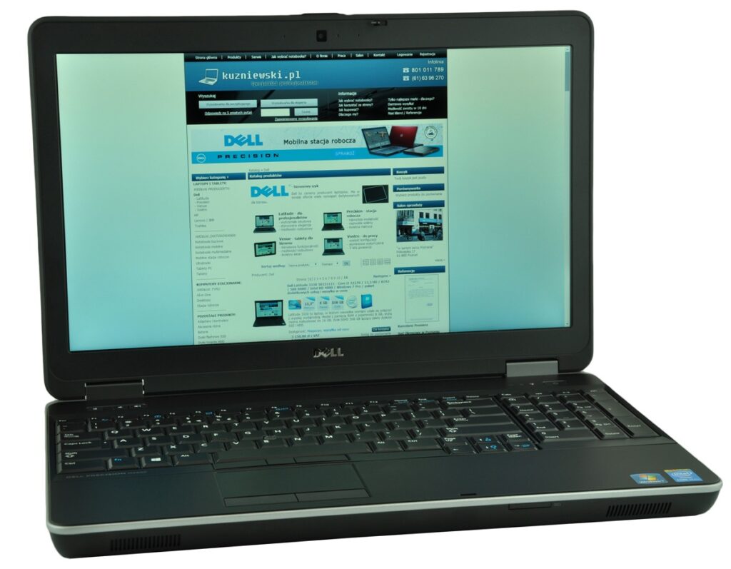 Dell laptop open and displaying a blue-themed website on the screen (Polish tech site with Dell banner).
