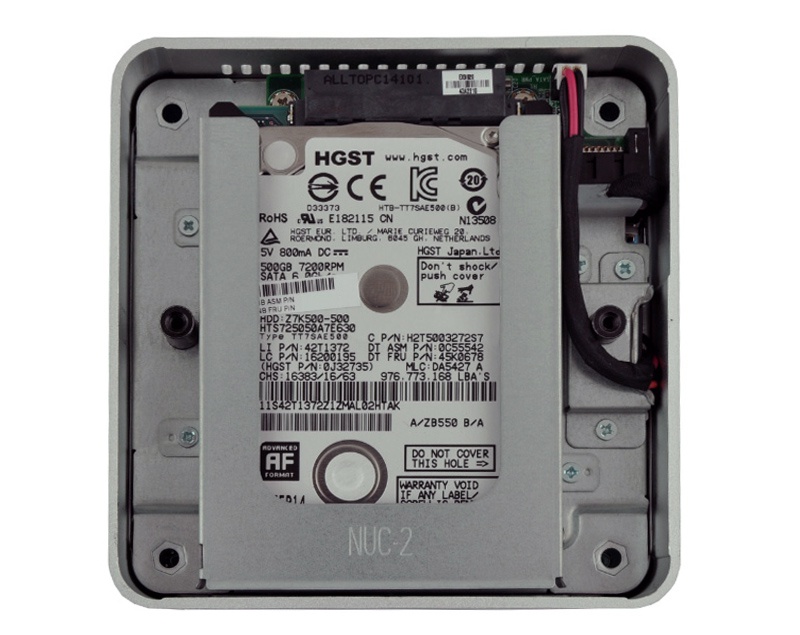 Internal 3.5-inch HGST hard drive mounted inside a silver enclosure, with a labeled barcode and visible cables on the right.