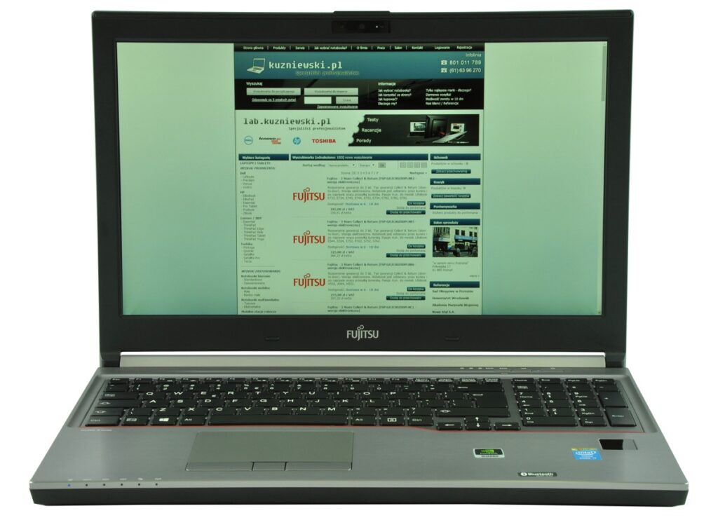 Open Fujitsu laptop displaying a website interface with a blue header and a list of product entries on screen.
