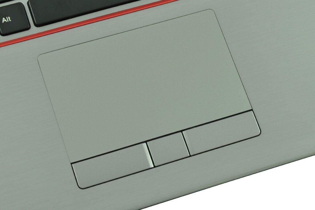 Close-up of a silver laptop touchpad with three hardware buttons below it and an Alt key visible at the top left.