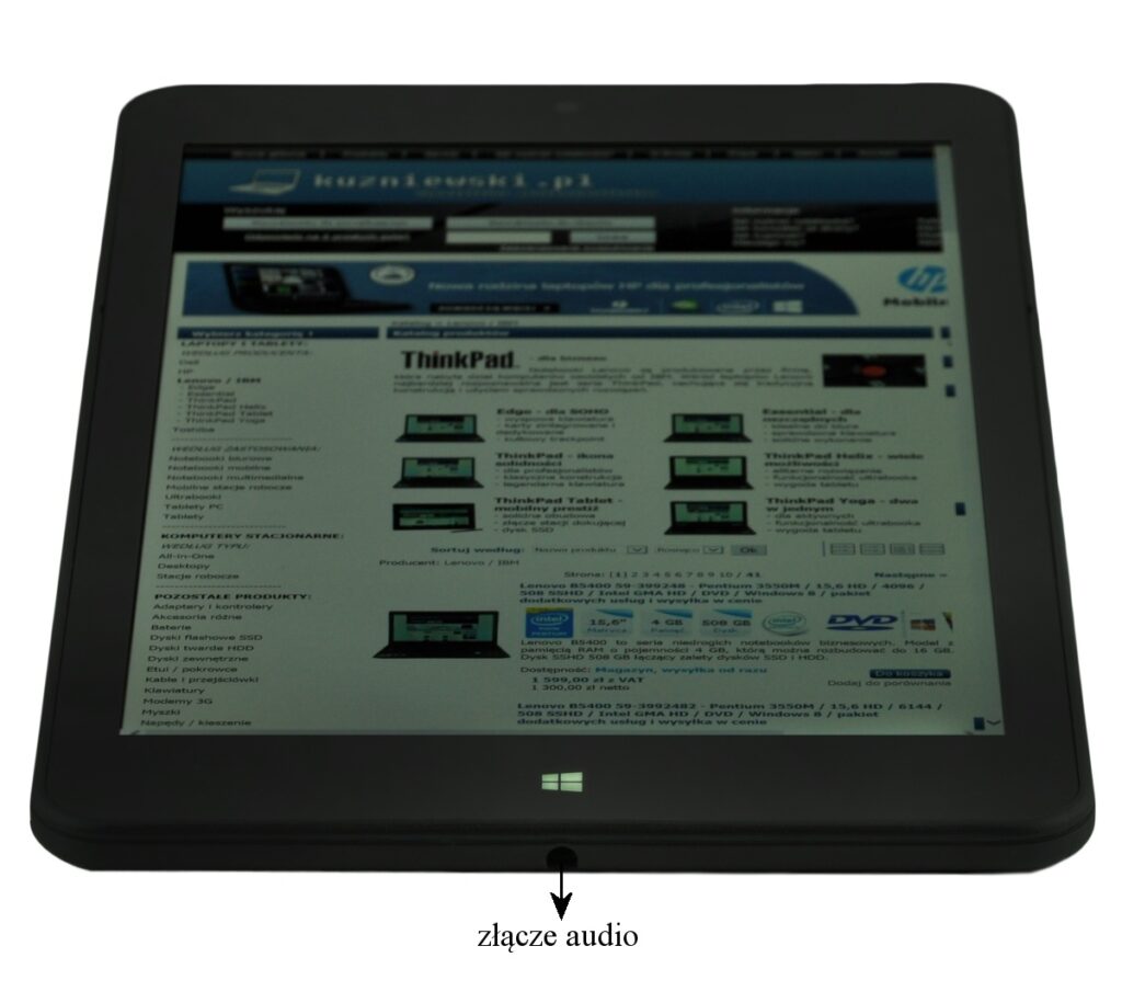Tablet displaying a webpage on its screen with a bottom audio jack labeled 'złącze audio'