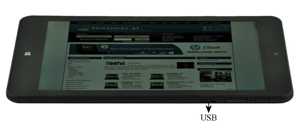 Tablet showing a webpage on the screen with a USB port highlighted along the bottom edge.