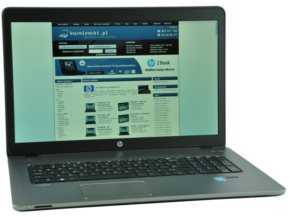 HP laptop displaying kuzniewski.pl homepage in a browser window on the screen
