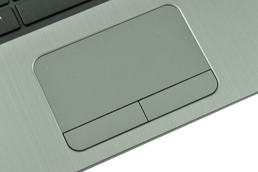 Close-up of a brushed aluminum laptop touchpad with left/right click buttons below it.