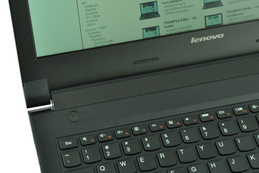 Close-up of a black Lenovo laptop showing the keyboard and a portion of the screen bezel with a Lenovo logo visible on the lid area.