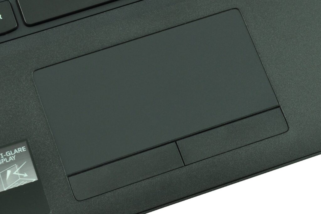 Close-up of a dark laptop touchpad with two horizontal buttons underneath.