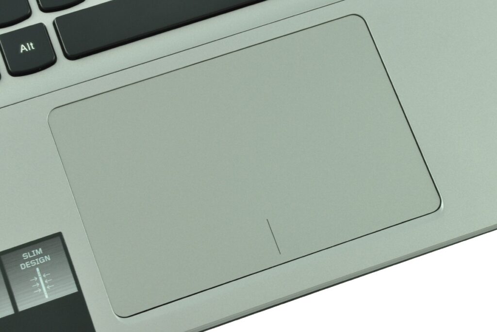 Close-up of a silver laptop touchpad with a visible Alt key on the keyboard corner.