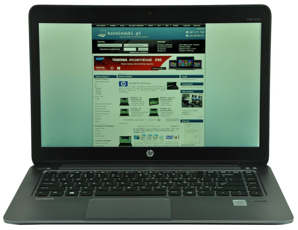 Open HP laptop displaying a website on the screen, with a blue header and product thumbnails visible on the page.