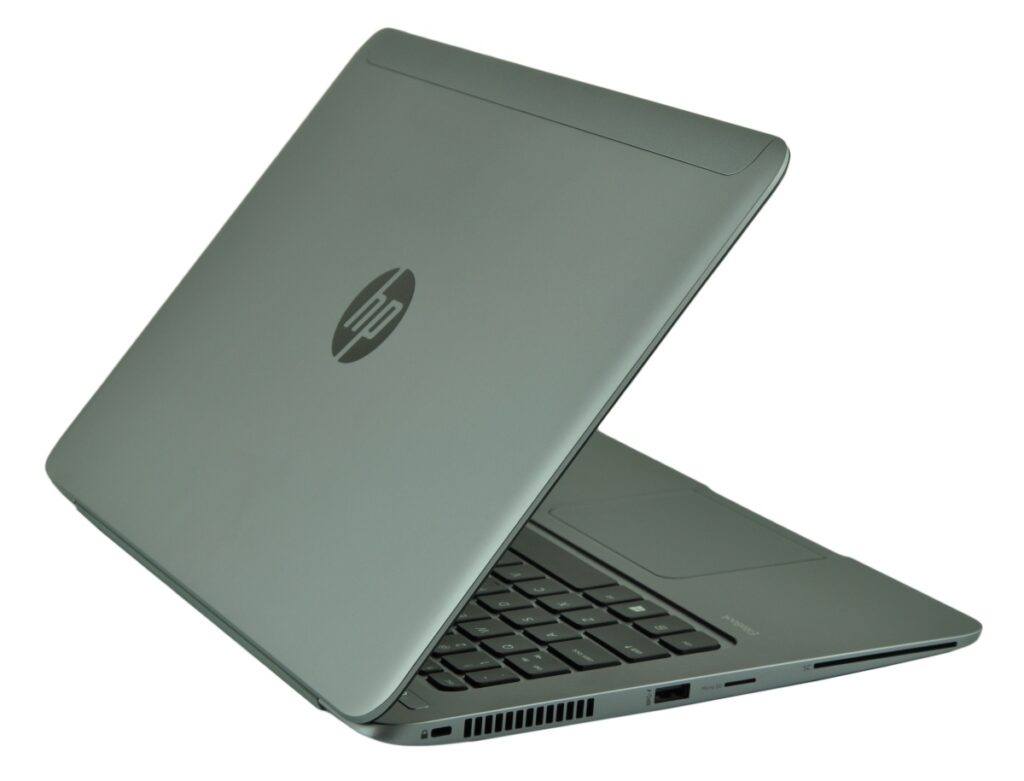 Silver HP laptop in a 3/4 view, lid half-open showing keyboard and side ports and vents