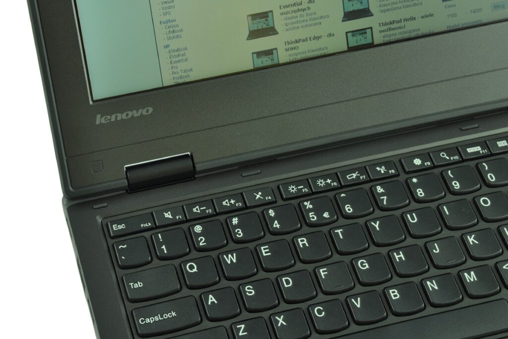Close-up of a Lenovo laptop showing the keyboard and a portion of the screen with a webpage visible on the display.
