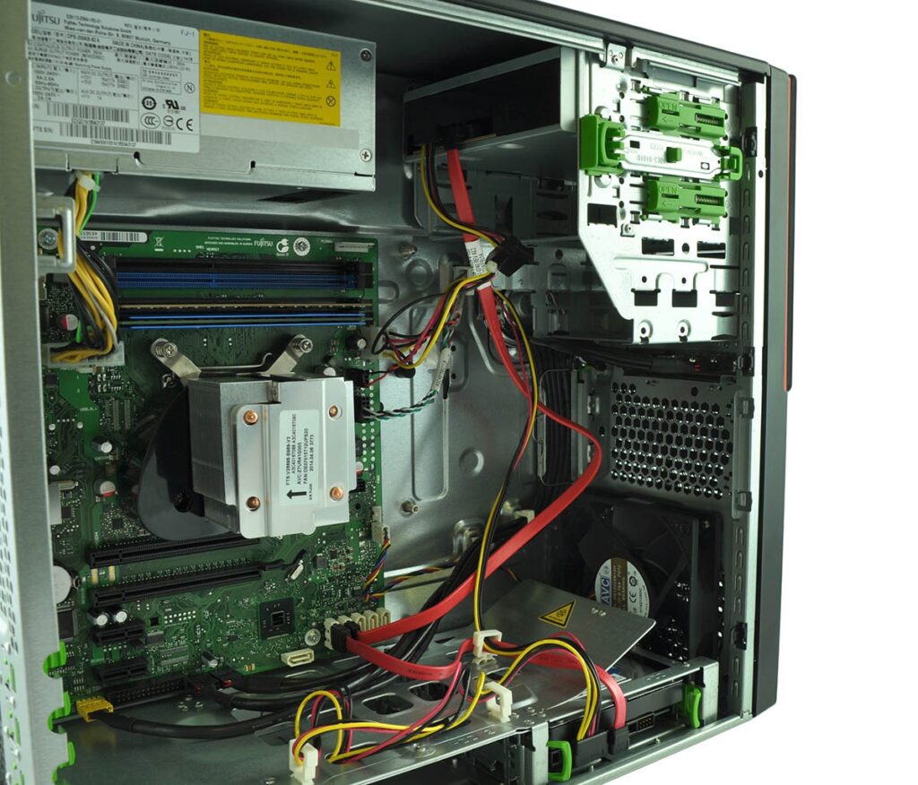 Open computer case interior with motherboard, RAM, PCIe cards, power supply, and tangled cables visible