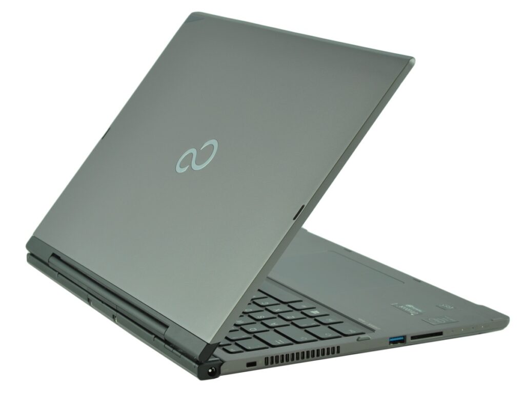 fujitsu-lifebook-t904-lk_130542 - lab-kuzniewski.pl - Testy laptopów, recenzje i porównania Slim gray laptop opened at an angle, keyboard visible with side ports