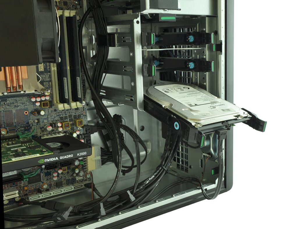 Inside a server chassis with a hot-swappable 3.5-inch hard drive in a bay and multiple cables nearby.